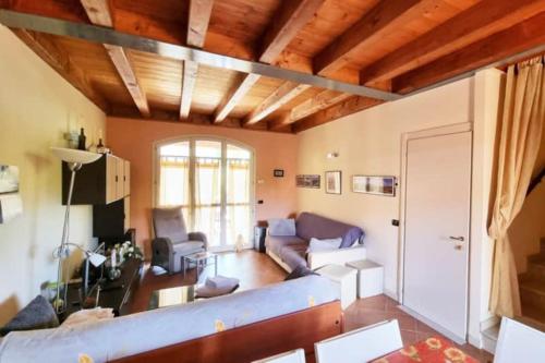 a living room with a blue couch in a room at Borgo del Torchio H3 ByBookinggardalake in Manerba del Garda