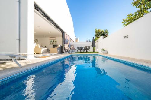 a swimming pool in the backyard of a house at Villa Lux - Golden Nelly By Algartur in Luz de Tavira