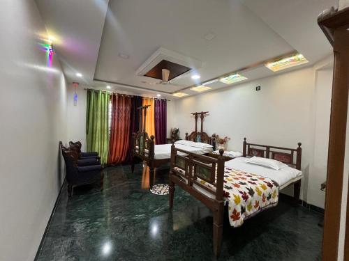 a bedroom with two beds and a chair in it at 3BHKVilla Panshet in Lavasa