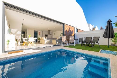 a swimming pool in front of a house at Villa Lux - Golden Nelly By Algartur in Luz de Tavira
