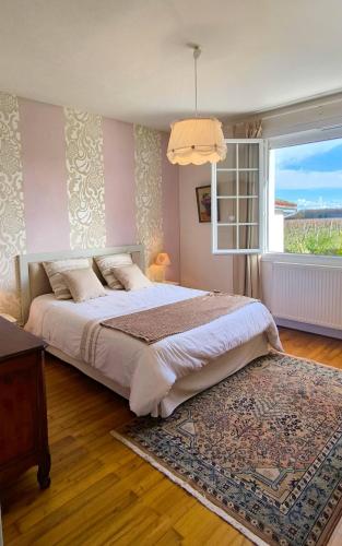 a bedroom with a large bed and a window at Gite 10pers, Piscine couverte, CRITEUIL,Charente in Criteuil-la-Magdeleine