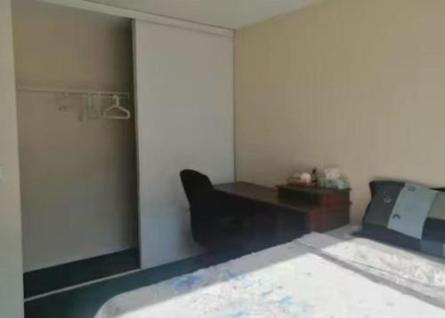 a room with a bed and a desk and a mirror at greenview mck sunny room in Calgary