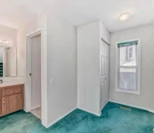 a white room with a sink and a mirror at greenview mck sunny room in Calgary