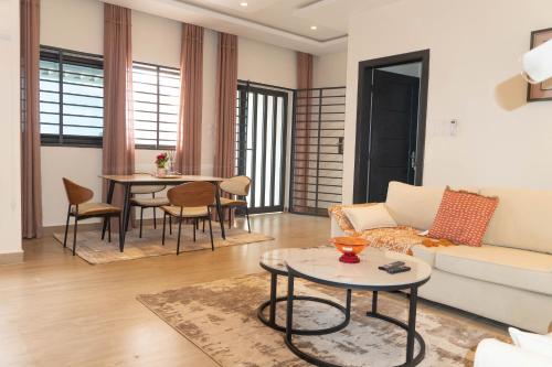a living room with a couch and a table at ResidHome A&M in Abomey-Calavi