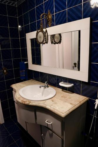 a bathroom with a sink and a mirror at Casarão José Morada in Belo Horizonte
