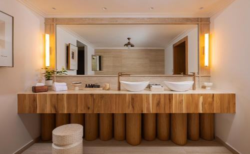 a bathroom with two sinks and a large mirror at Galei Kinneret Hotel in Tiberias