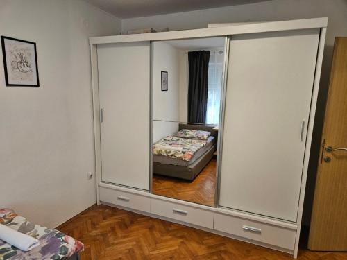 a large mirror in a room with a bed at City Center Luxury Apartment in Mostar