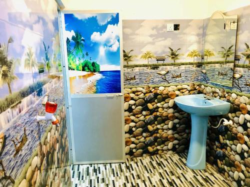 a bathroom with a painting of a beach at Umami Japanese House Tangalle in Tangalle
