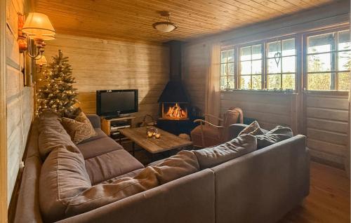 a living room with a large couch and a christmas tree at Stunning Home In Ljørdalen With Sauna in Ljørdalen