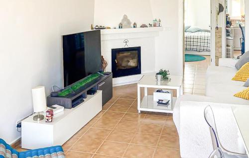 a living room with a tv and a fireplace at 2 Bedroom Awesome Apartment In Facinas - Tarifa in Facinas