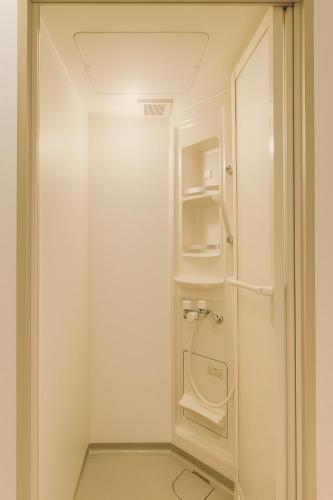 a small bathroom with a washer and dryer at Yellow House Niseko in Kutchan