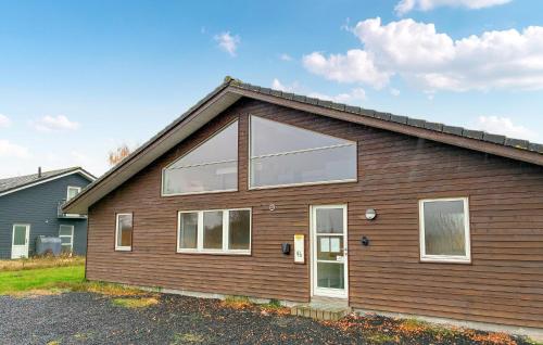 a house with a large window on the side of it at Beautiful Home In Rødby With Wifi in Tjørnebjerg