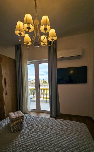 ein Schlafzimmer mit einem großen Bett mit einem großen Fenster in der Unterkunft Urban flat in Chalkida