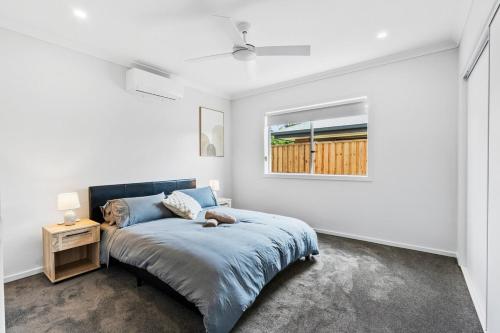 Ένα ή περισσότερα κρεβάτια σε δωμάτιο στο Fresh and Stylish 4BR Getaway Near Local Parklands