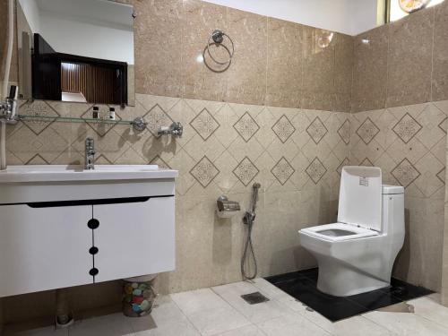 a bathroom with a toilet and a sink at Sapphire Stays Hotel and Restaurant Peshawar in Peshawar