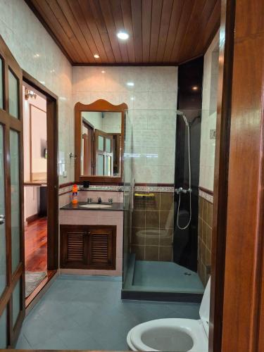 a bathroom with a shower and a sink at Nur Nur Residence and villa in Surin Beach