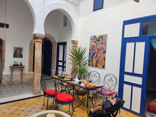 a room with a table and chairs in a building at Riad Safi médina in Safi