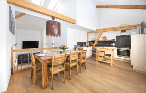a kitchen with a wooden table and chairs at GM-Stays Wendelstein Lodge - Sauna & Alpenblick - BRIGHT Collection in Fischbachau