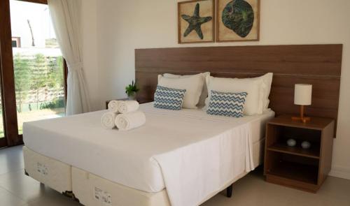 Ένα ή περισσότερα κρεβάτια σε δωμάτιο στο Casa de Praia The Coral Beach Resort