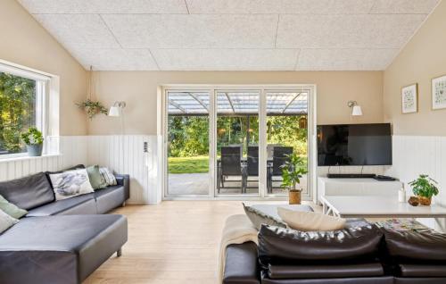 a living room with a couch and a tv at Gorgeous Home In Farsø With Wifi in Hole