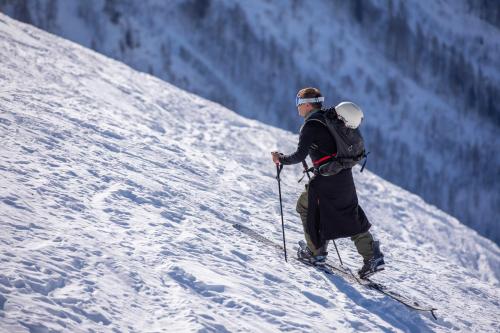 a man is skiing down a snow covered slope at Résidence Androsace 53 - Happy Rentals in Chamonix-Mont-Blanc