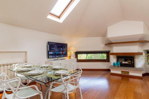 a dining room with a table and chairs and a fireplace at Il camino felice - 201 by Houset in Monza