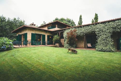a house with a lawn in front of it at HolaCamp Camino Apartamentos Turísticos in O Pino 
