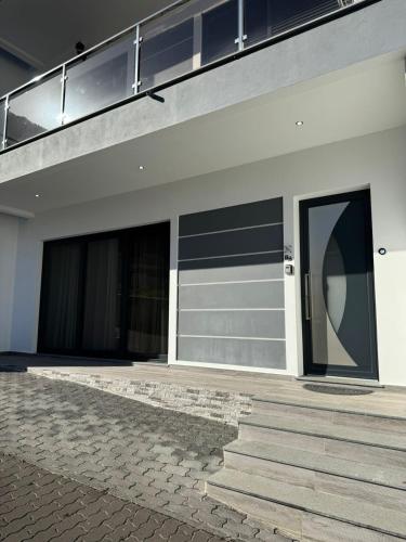 a building with two garage doors and stairs on it at Charming Holiday Home with Free Private Parking in Machico