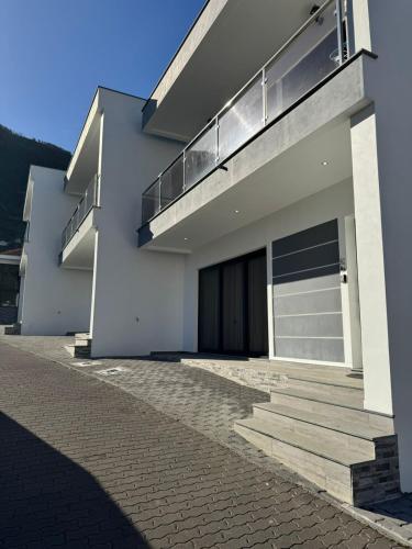 a white house with a door and stairs on it at Charming Holiday Home with Free Private Parking in Machico