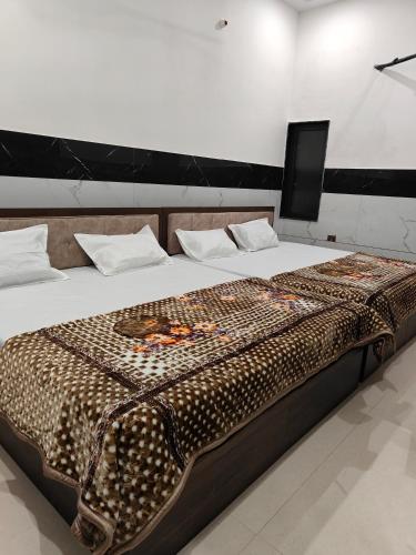 a large bed in a room with at Hotel Sudha Palace in Khātu
