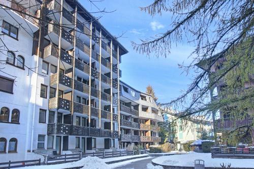 an apartment building with snow on the ground at Chamonix Sud - Grepon 102 - Happy Rentals in Chamonix-Mont-Blanc