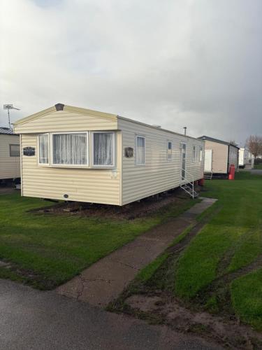 a mobile home is parked in a yard at TLJ Caravan Hires in Mablethorpe