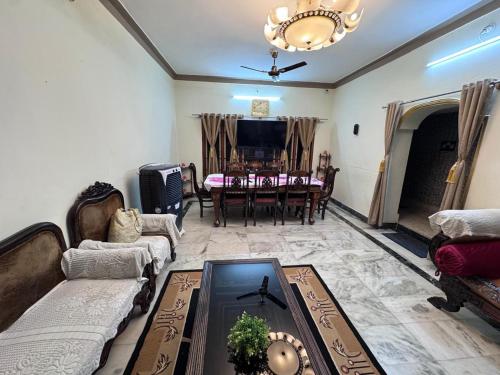 a living room with a couch and a table at Rooms in appartment by LUXE in Mysore