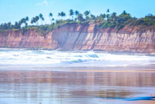 a view of a beach with the ocean at Orla Pousada & Café in Parnamirim