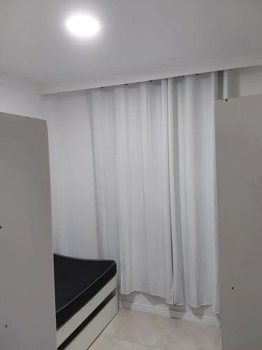 a room with a window with white curtains at Bem vindo ao APTO 403 in Florianópolis