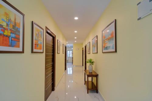 a hallway with paintings on the walls at FabHotel Srikara Grand Luxury Rooms in Hyderabad