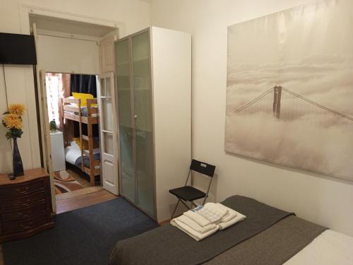 a bedroom with a bed and a painting on the wall at Quarto C in Lisbon