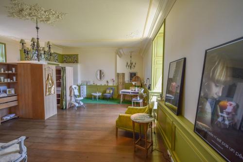 a living room with a couch and a tv at Domaine d'Essendiéras in Saint-Médard-dʼExcideuil