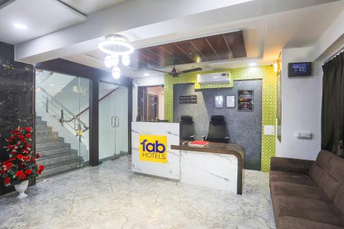 a lobby with a jobolis sign on the wall at Hotel Brook View in Surat