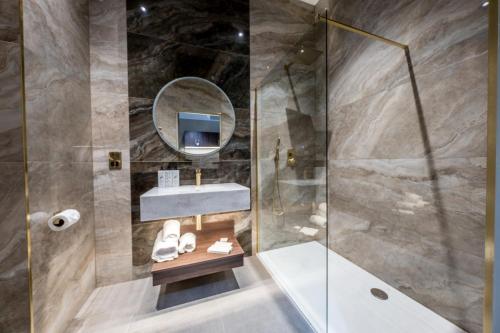 a bathroom with a sink and a shower at Walled City Hotel in Derry Londonderry