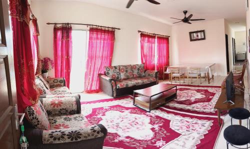 a living room with a couch and a table at Homestay No 68 Raub in Raub