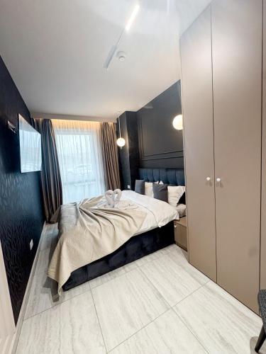 a bedroom with a large bed in a room at Sky Escape - Private Parking, Kingsize Bed & More in Cluj-Napoca