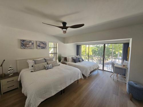 a bedroom with two beds and a ceiling fan at Day Dreams Key Largo in Key Largo