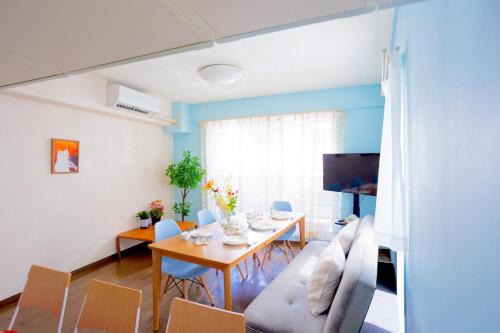 a dining room with a table and chairs at MIKO'S HOUSE SETAGAYA, Peaceful Tokyo Home Near Shinjuku, Experience Authentic Local Living, Lucky Cat Temple, Super Market 東京の家 新宿10分 隠れ家カフェ 豪徳寺 in Tokyo