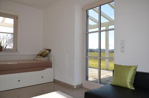 a living room with a couch and a window at Ferienhaus zur Tulpe, Legoland in Ettenbeuren