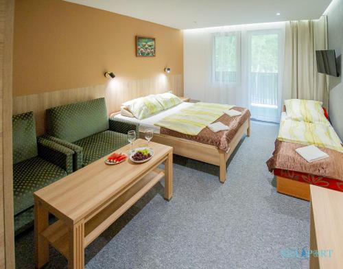 a hotel room with a bed and a couch at SeaPort Resort in Łeba