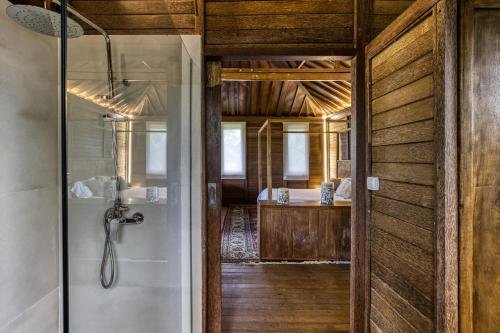 a bathroom with a shower and a glass door at Casa Bali Costa Brava in Llofríu