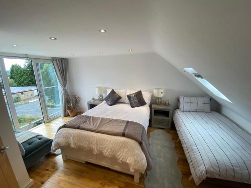 a bedroom with a bed and a bench next to a window at Modern Room in Cardiff, Wales in Cardiff