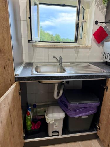 a bathroom with a sink and a window above it at Dea Bendata HERMES in Palestrina