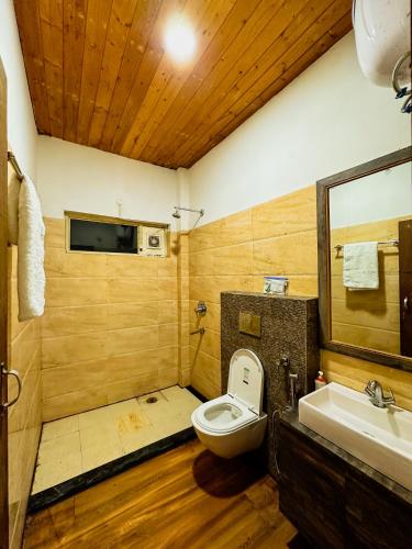 a bathroom with a toilet and a sink at AR Riyasat in Garli